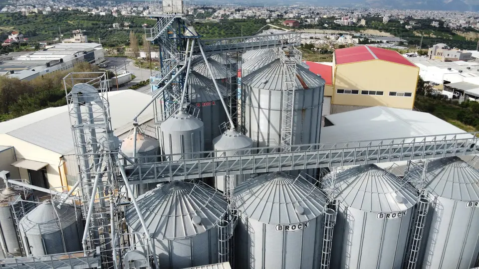 Aerial view of a feed mill with silos and conveyor gantries